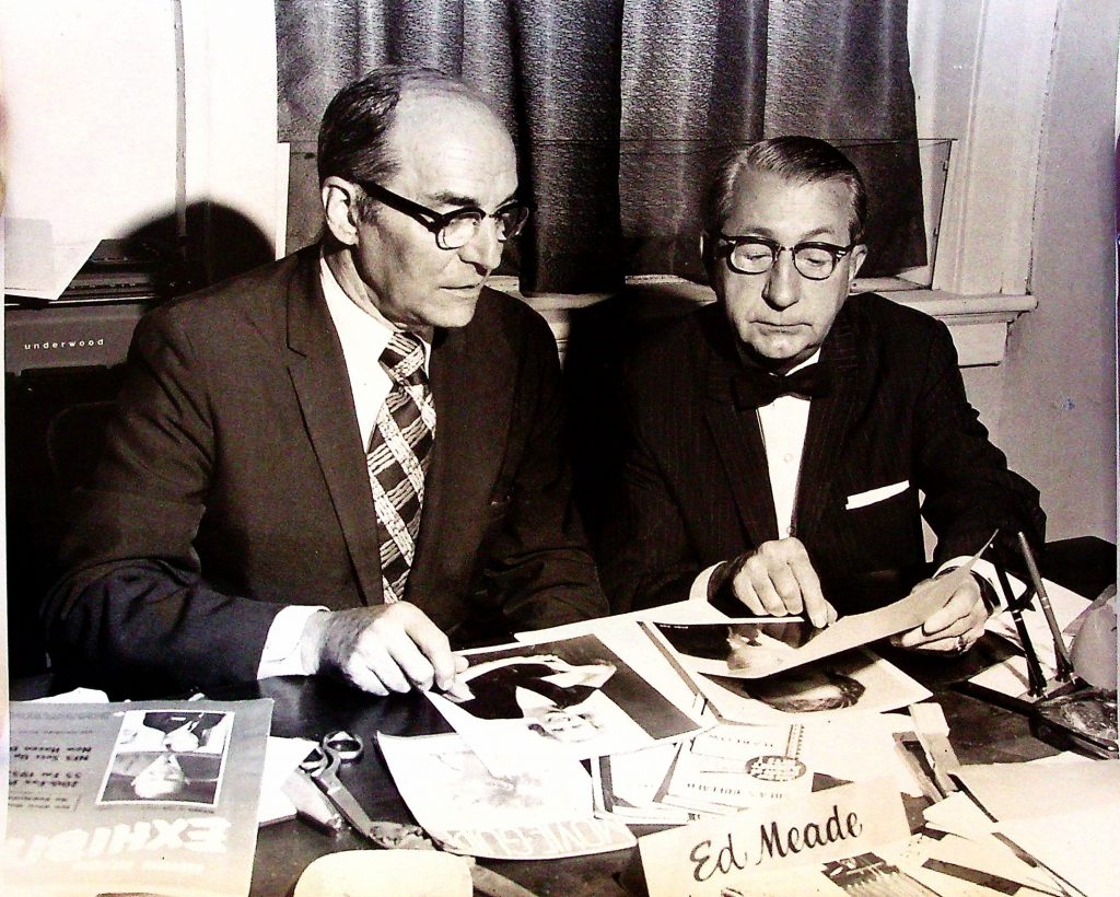Ed Meade (left) and Ed Miller, were long-time friends and business associates. This photo was taken in Meade's advertising office in the Wurlitzer Building, looking over autographed photos of Hollywood stars who appeared in Buffalo theatres during their carees.
