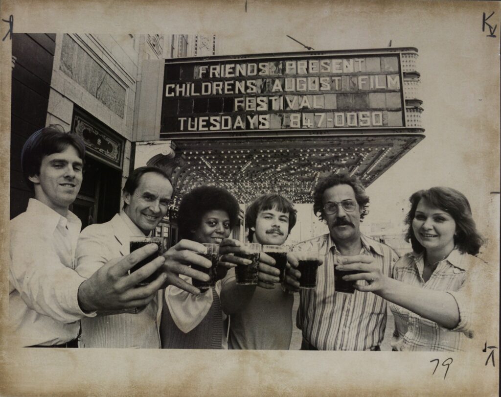 These Friends of Buffalo led by restoration director L. Curt Mangel reacted with pleasure as they toasted the future of the landmark theater. From left are Mangel, George Wands and Carl Kosmerl. 