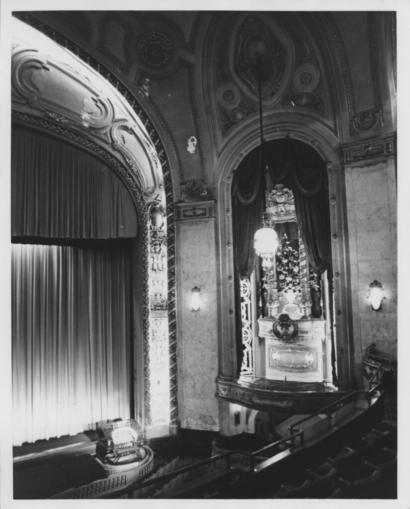 View from balcony in theater auditorium showing Wurlitzer organ in raised position.