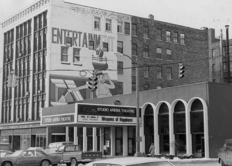 Down the street at 710 Main Street, our new neighbors Studio Arena had just moved into the old Palace Burlesque theater. Note the two painters working on the Entertainment mural - it's still there today! 
