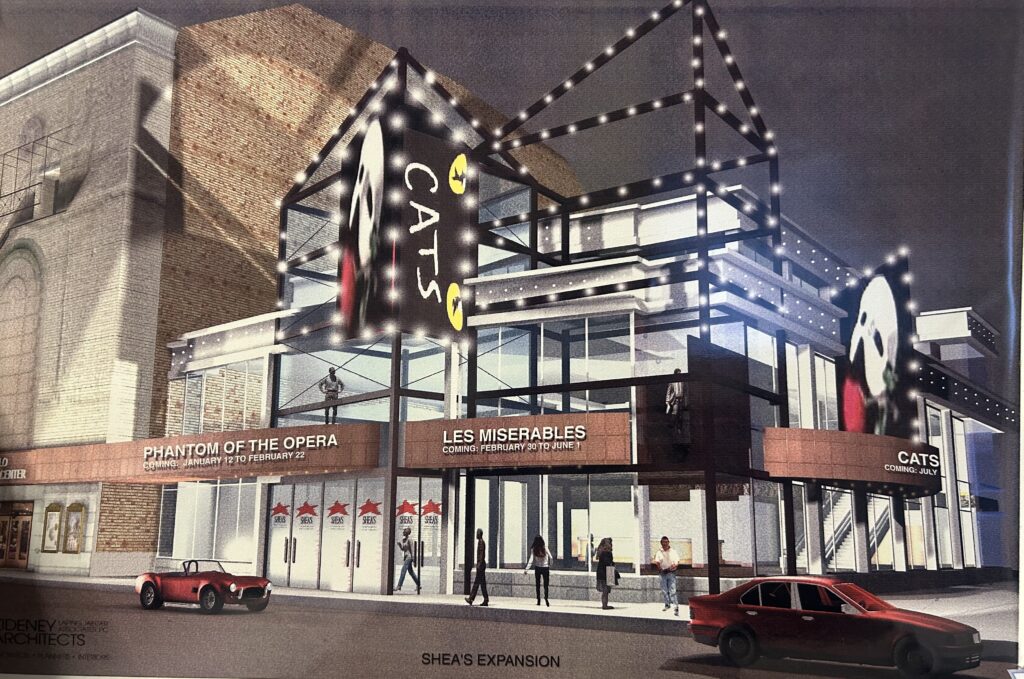 This was the earliest iteration of the elevator tower expansion, circa 1990's, featuring the two hottest shows on Broadway at the time: <i>Cats</i> and <i>The Phantom of the Opera</i>! As you can see, the design has changed a lot over the decades fundraising.